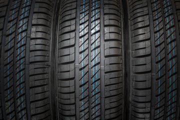 New and unused car tires against dark background