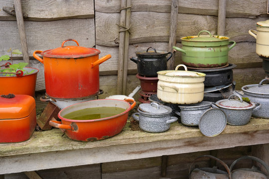 Old Dutch vitreous enamel coated Pans for decoration in a Garden.