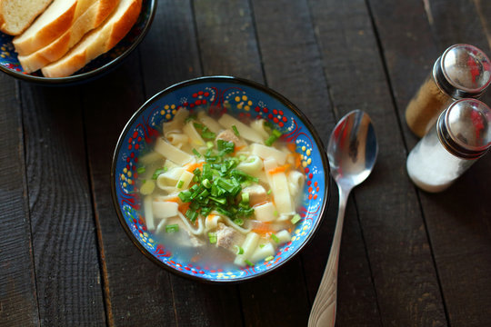 soup lagman on wooden background