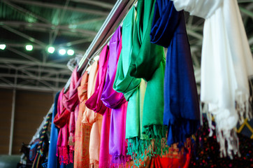 Fototapeta na wymiar many pashmina foulards hanging from a market stall 