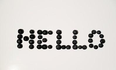 Hello sign word letters writing from blueberries on white background