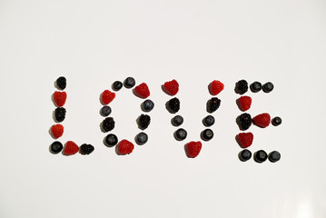 Love sign word letters writing from berries: raspberry, blueberry and blackberry