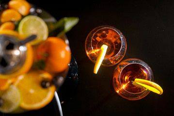 Pair of glasses with alcoholic drink beverage wine cocktail and hookah with fruits black background isolated