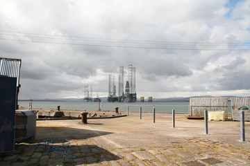 Cromarty Harbour overlooking oil rigs in the Firth. Black Isle, Scotland