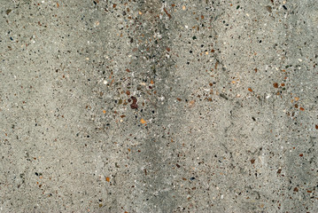 background, texture - gray rough concrete wall with colored stones of aggregate