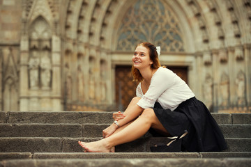 portrait of smiling girl sitting on stairs