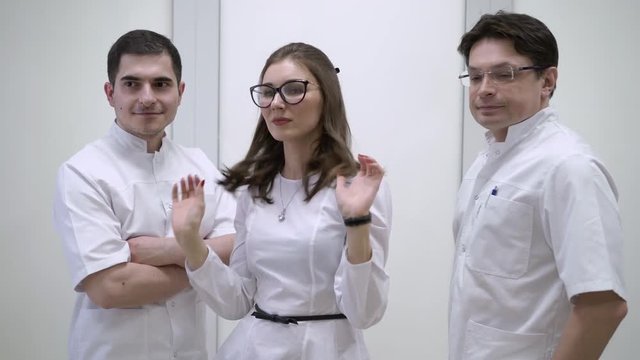 Doctors in hospital in white uniform posing