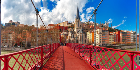 Panoramic view of Saint Georges church and pedestrian footbridge across Saone river, Old town with Fourviere cathedral in the sunny day in Lyon, France - obrazy, fototapety, plakaty