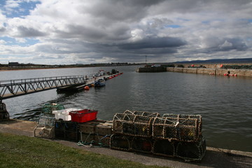 Crab pots and boats in Portmahomack harbour, scottish highlands, Scotland