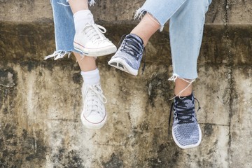 Two women are sitting at the wall during trip