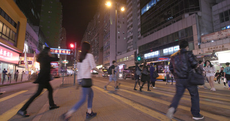 People crossing the road at night
