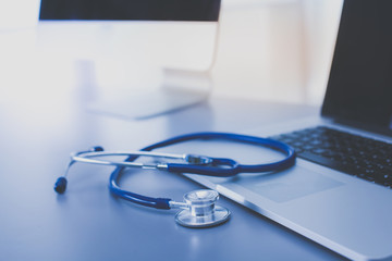 Medical equipment: blue stethoscope and tablet on white background. Medical equipment