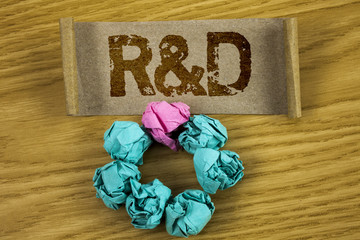 Writing note showing R D. Business photo showcasing Research and Development Scientific Investigations Innovations written on Folded Cardboard Paper Piece wooden background Paper Balls