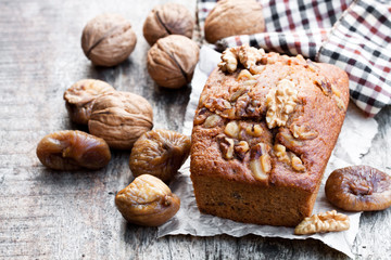 Homemade  fig and walnut loaf cake on old wooden table