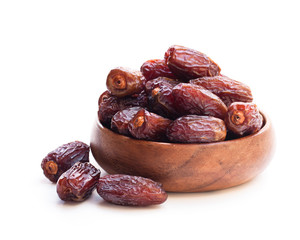 Dried  dates in wooden bowl isolated on white