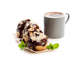 Homemade  profiteroles with cup of coffee isolated on white
