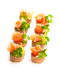 Croustades  crispy pastry cases filled with salted salmon and avocado isolated on white
