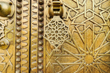 Close view of golden door with  knocker