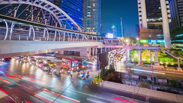 Time-lapse of public sky walk and traffic at Chong Nonsi sky train station at night, Bangkok, Thailand