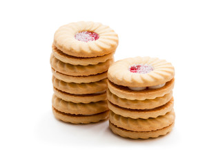 Stacked  shortcake biscuits sandwiched with cream and jam isolated on white