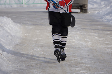 Hockey player with stick on the ice.