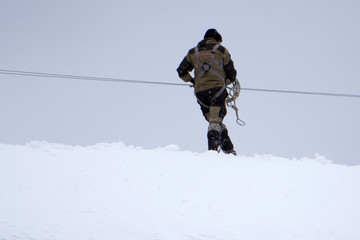 rises on a snowy ridge in Entrepreneurship, hard work, teamwork: the concept of climbing.