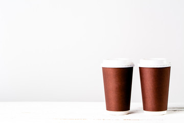 Takeaway coffee cup isolated. Disposable cups with paper in brown.