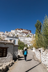 Traveller walking into Thiksey Monastery (Thiksey Gompa), Leh Ladakh, Jammu and Kashmir, India