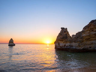 Beautiful landscape with amazing sunrise on the rocky atlantic ocean coast within the Lagos, Portugal.