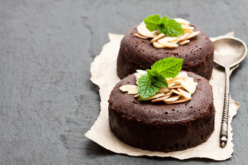 Chocolate  fondant with almonds on wooden table