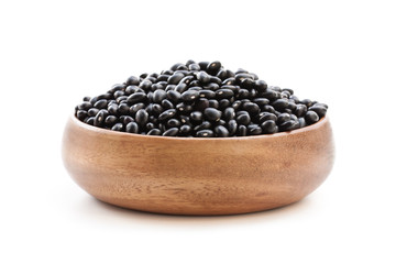 Raw  black beans in wooden bowl isolated on white