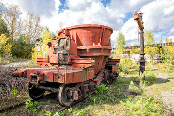Fototapeta na wymiar Old industrial railway train bucket on Mining and metallurgical plant