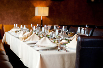 Served desk in a restaurant with muted light ready for the arrival of guests