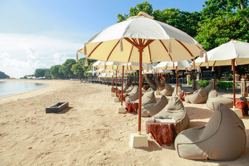 Many bean bags outdoor on the sand beach with ocean view