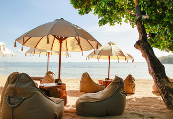 Many bean bags outdoor on the sand beach with ocean view © Space_Cat