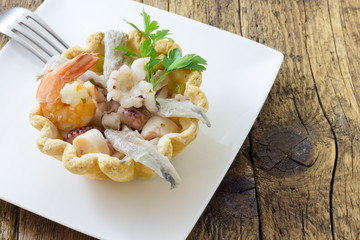 Seafood appetizer in puff pastry basket