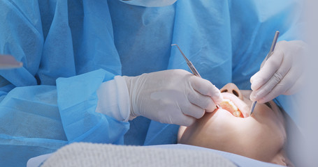 Patient having ultrasound cleaning at dental clinic