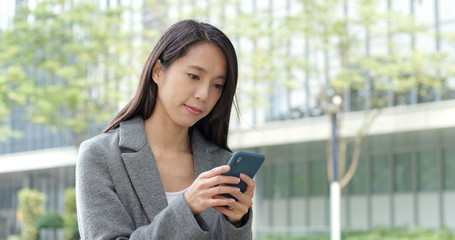 Business woman work on smart phone at outdoor