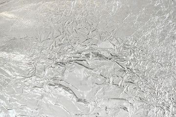 Crumpled aluminum foil silver background.