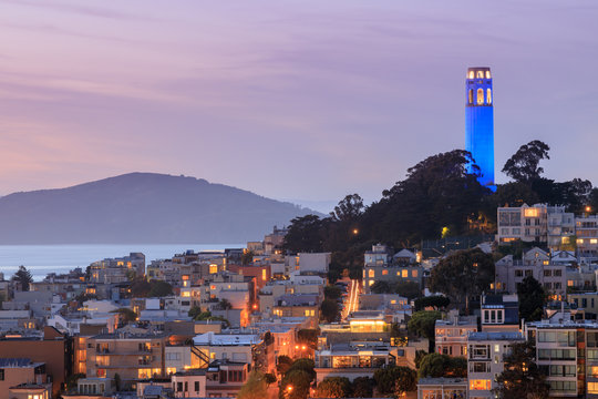 Coit Tower lit blue in recognitiomn of the Golden State Warriors. Taken from a downtown building rooftop. San Francisco, California, USA. 