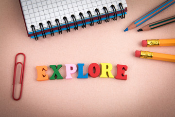 Explore. Wooden letters on the office desk, informative and communication background