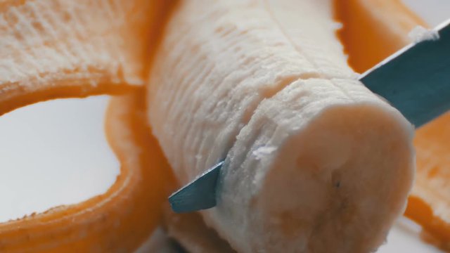 Woman sexually cut with a knife of purified banana, macro close up view