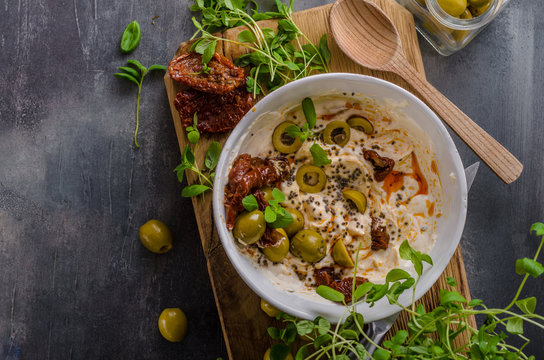 Fresh cheese with olives, dried tomatoes