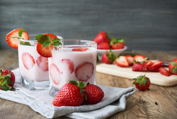 Strawberry yogurt in a glass on a wooden table       