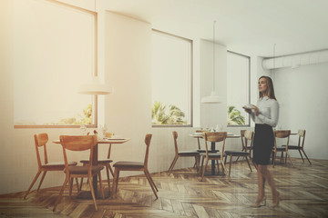 White loft restaurant interior, side view, woman