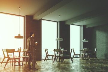 Corner of a gray brick loft cafe toned