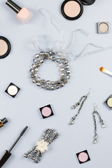 Woman fashion accessories, jewelry and cosmetics on stylish gray background.