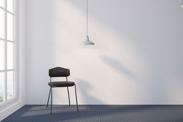 Empty room with white walls and a chair