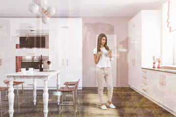 Fototapeta na wymiar Woman in a luxury kitchen with a marble table