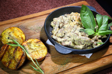 Beef Stroganoff from beef and baked potatoes.